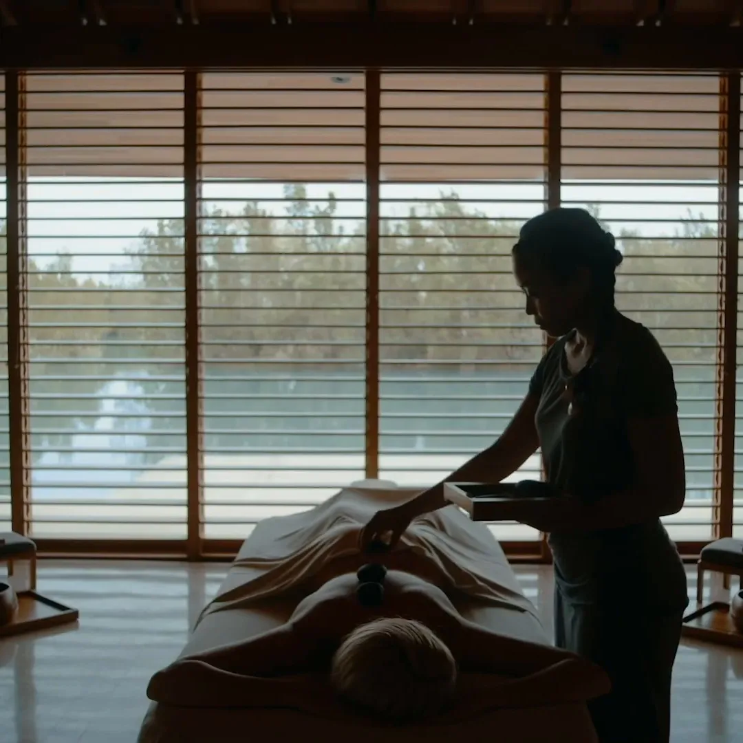 Spa therapist preparing a treatment room at Amanyara